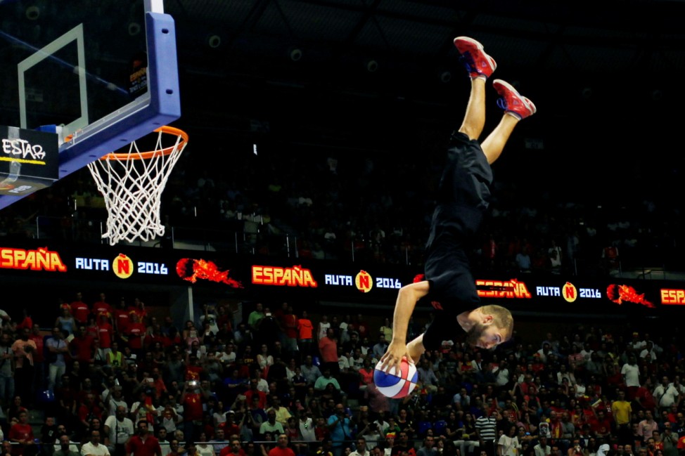 A member of the 'Crazy dunkers' group performs during the half-time of a friendly basketball game between Spain and Lithuania in Malaga