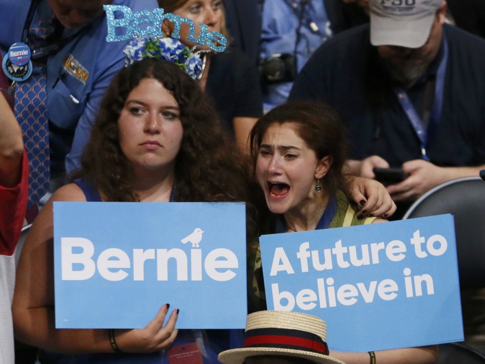Two supporters of former Democratic presidential candidate Senator Bernie Sanders react as they listen to him speak at the Democratic National Convention in Philadelphia, Pennsylvania