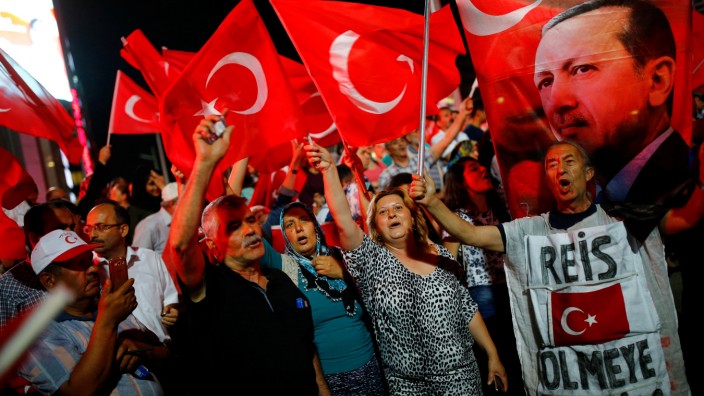 People shout slogans and wave Turkish national flags as they have gathered in solidarity night after night since the July 15 coup attempt in central Ankara