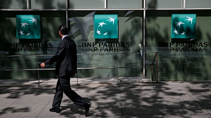 A man walks past a BNP Paribas bank office in Madrid