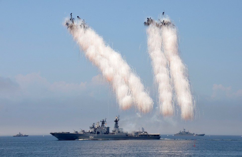 Russian warships sail past exploding anti-missile ordnance during a rehearsal for the Navy Day parade in the far eastern port of Vladivostok, Russia
