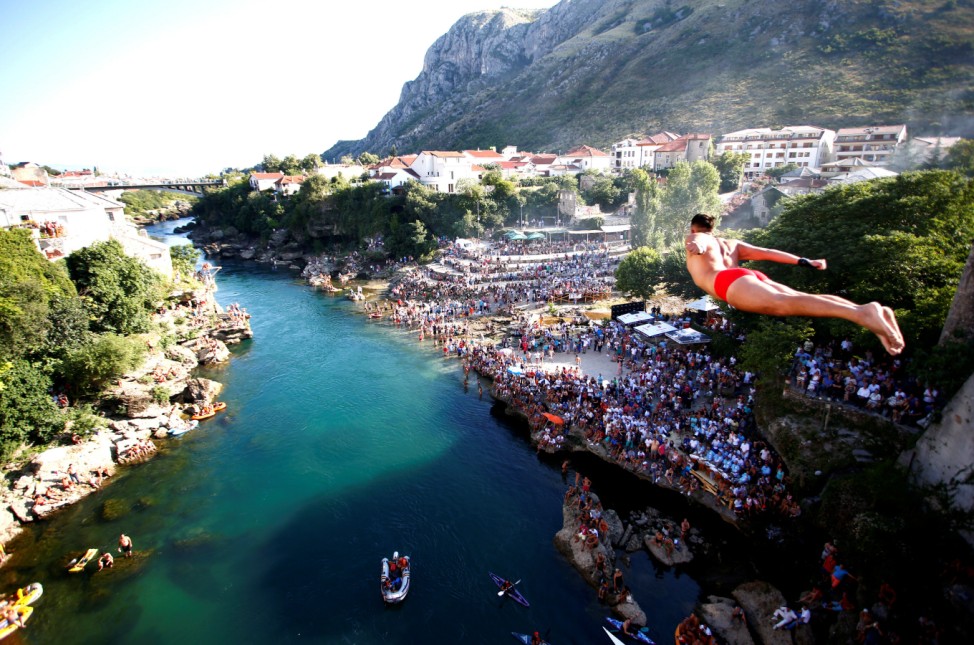 A man jumps from the Old Bridge during 450th traditional diving competition in Mostar