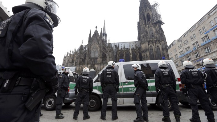German riot police stand in front of the Cologne Cathedral during a protest of supporters for Turkish President Erdogan in Cologne