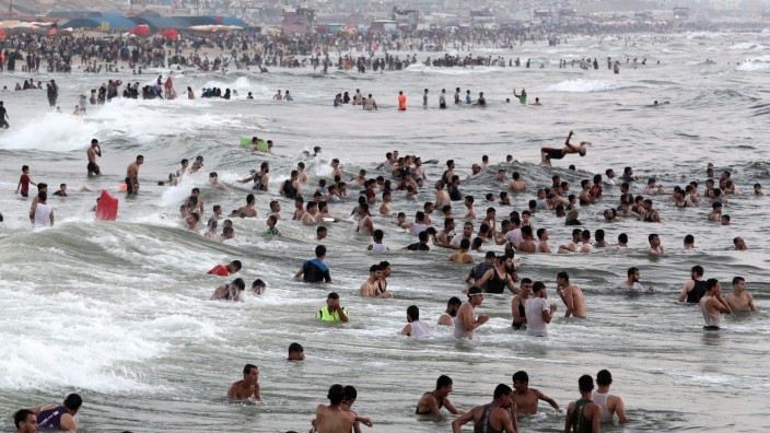 Palestinians enjoying the hot weather at a beach