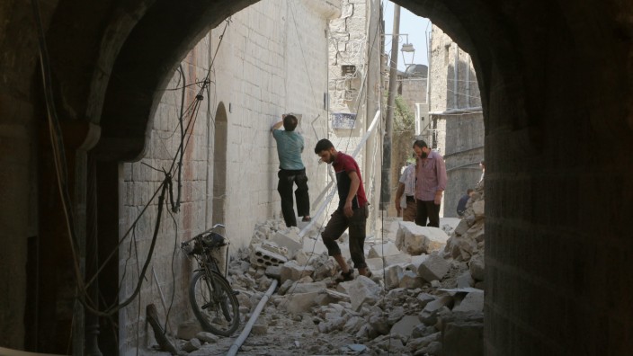 Residents inspect their damaged homes after an airstrike on the rebel-held Old Aleppo