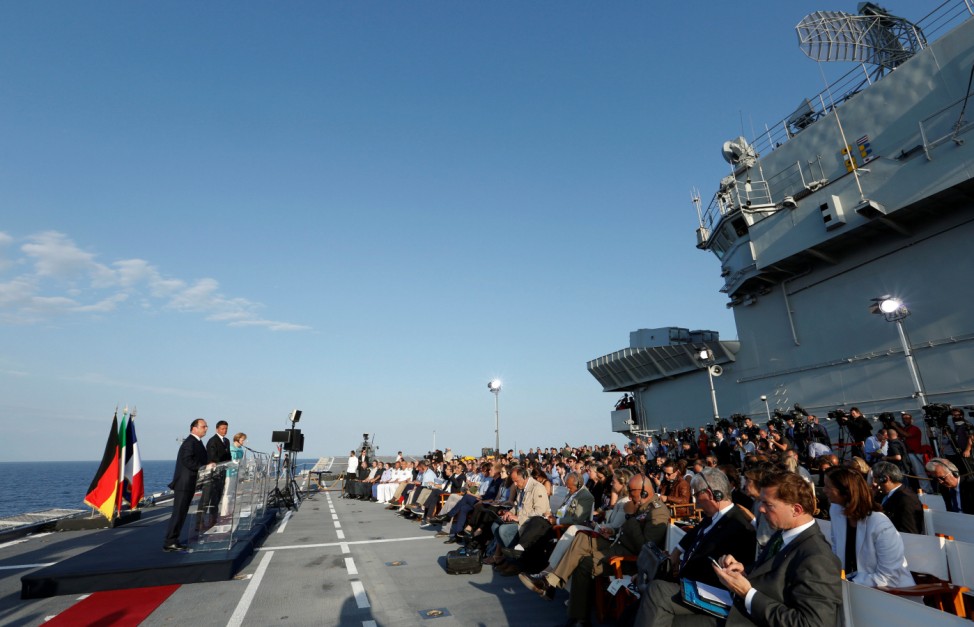 Italian Prime Minister Renzi, German Chancellor Merkel and French President Hollande lead a news conference on the Italian aircraft carrier Garibaldi off the coast of Ventotene island