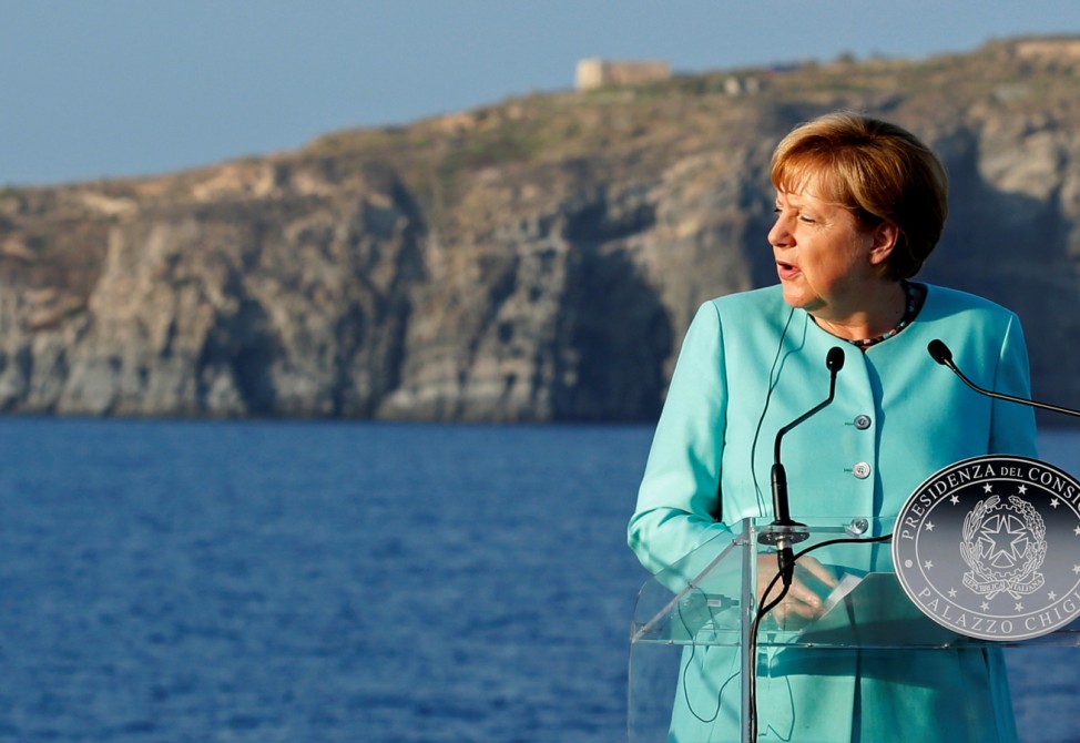 German Chancellor Merkel speaks during a news conference on the Italian aircraft carrier Garibaldi off the coast of Ventotene island