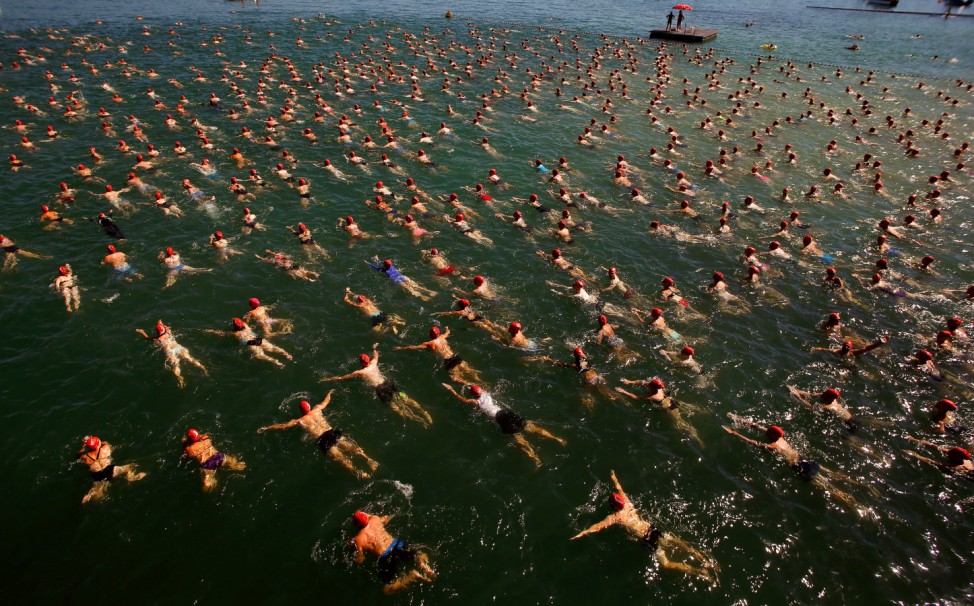People swim during the annual public Lake Zurich crossing swimming event over a distance of 1,500 metres (4,921 ft) in Zurich