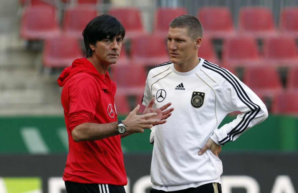 German national soccer team coach Loew and Schweinsteiger talk during a training session in Cologne