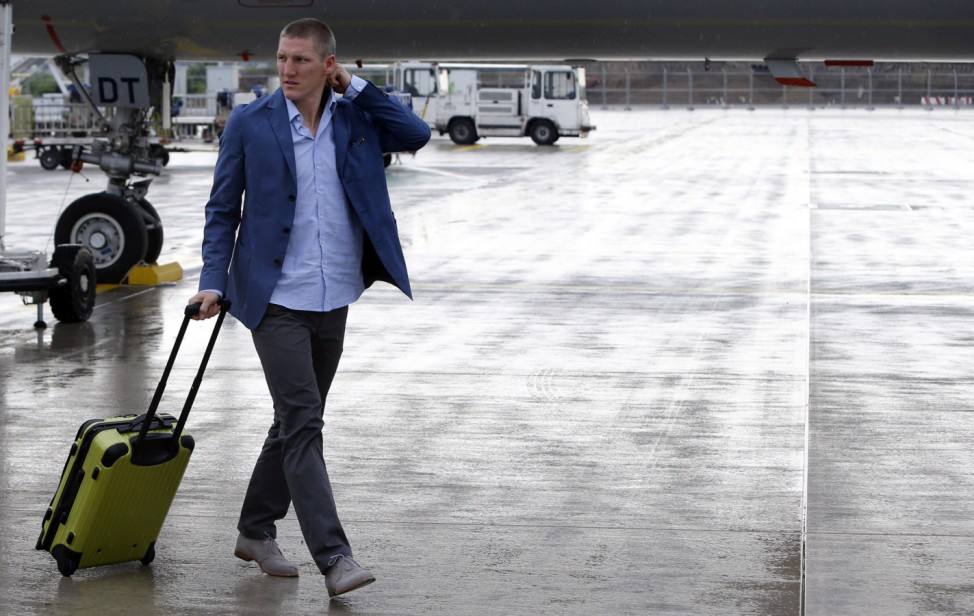 Germany's Bastian Schweinsteiger  walks on the tarmac at Frankfurt Airport,