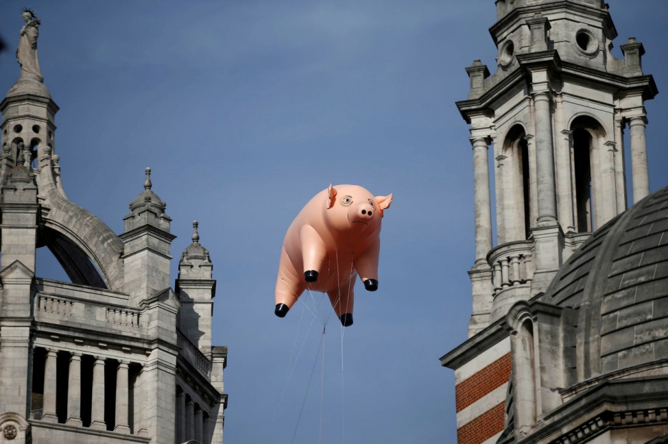An inflatable pig from the band Pink Floyd floats over the Victoria and Albert Museum to promote 'The Pink Floyd Exhibition: Their Mortal Remains'