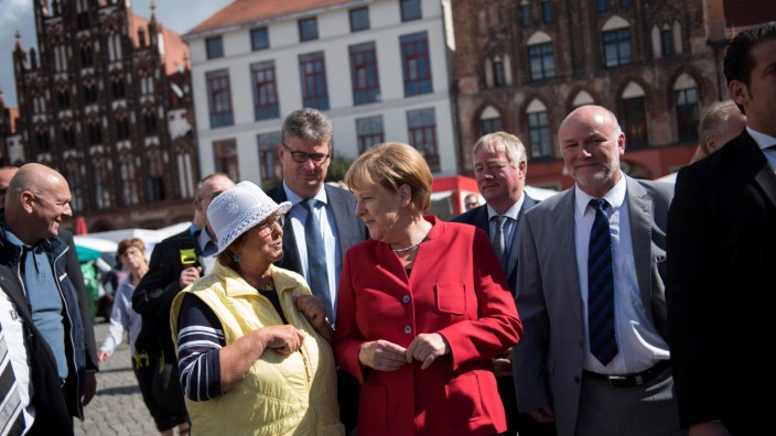 German Chancellor Merkel and CDU candidate Liskow visit market in Greifswald