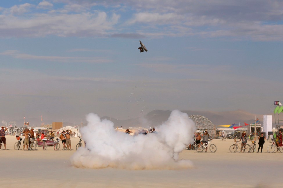 An anvil is launched into the air with explosives as approximately 70,000 people from all over the world gather for the 30th annual Burning Man arts and music festival in the Black Rock Desert of Nevada