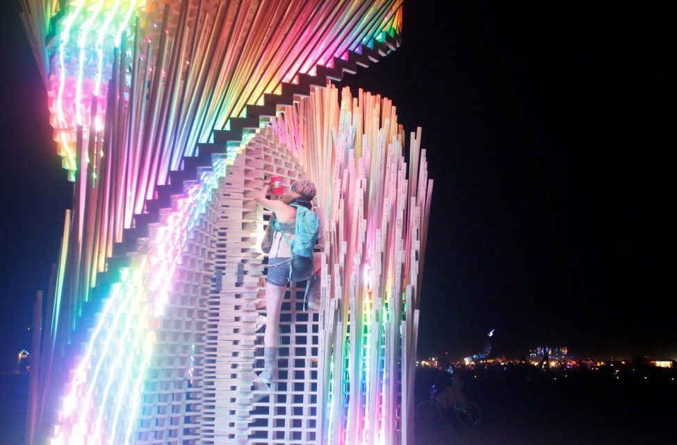 A participant climbs the art installation Tangential Dreams as approximately 70,000 people from all over the world gather for the 30th annual Burning Man arts and music festival in the Black Rock Desert of Nevada, U.S.