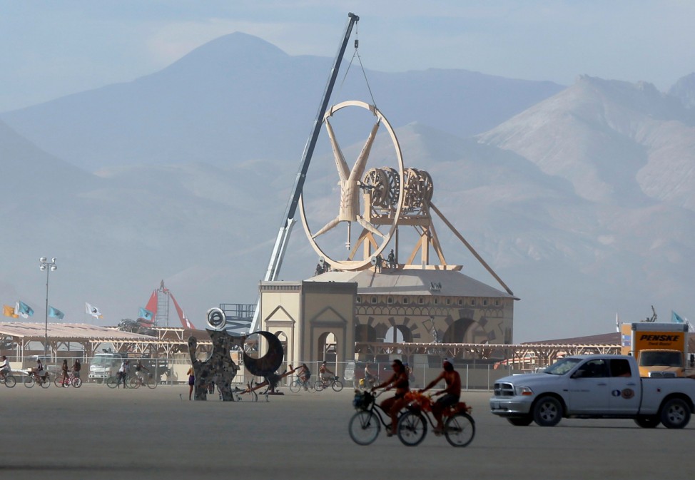 Work continues on the Man as approximately 70,000 people from all over the world gather for the 30th annual Burning Man arts and music festival in the Black Rock Desert of Nevada