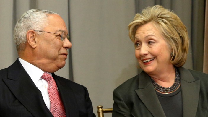 Powell and Clinton listen to remarks at a groundbreaking ceremony for the U.S. Diplomacy Center at the State Department in Washington
