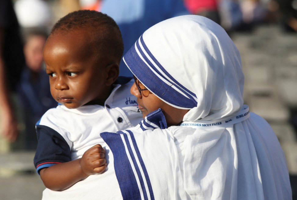 A nun, belonging to the global Missionaries of Charity, holds a child before a mass celebrated by Pope Francis for the canonisation of Mother Teresa of Calcutta in Saint Peter's Square at the Vatican