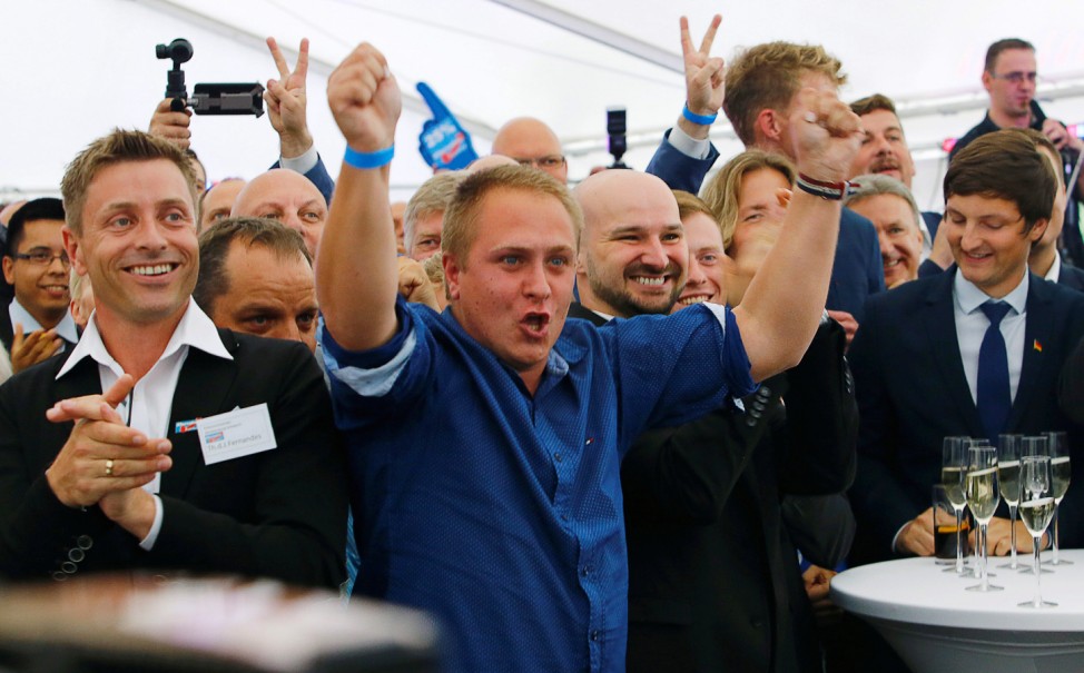 People react to first exit polls during the Mecklenburg-Vorpommern state election at the anti-immigrant Alternative for Deutschland (AfD) post election venue in Schwerin
