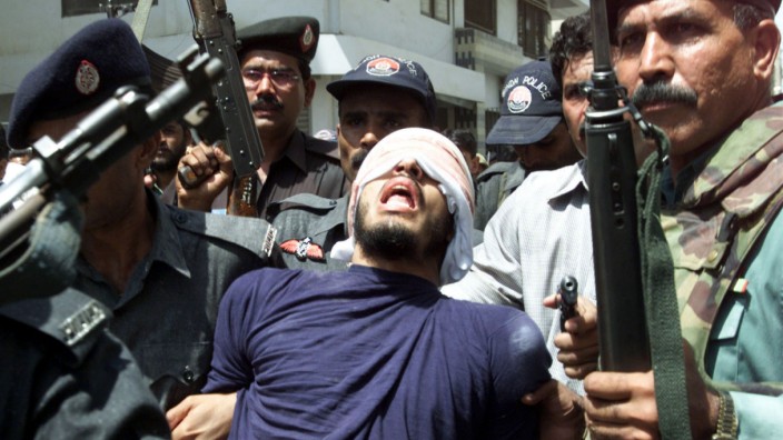 -FILE PHOTO 11SEP02- Security officials escort a gunman (C) arrested after a gunbattle in the southe..