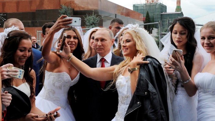 Russian President Vladimir Putin poses for a photo during the celebrations for the City Day at Red Square in Moscow