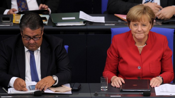German Chancellor Angela Merkel and German Economy Minister Sigmar Gabriel attend a meeting at the lower house of parliament Bundestag on 2017 budget in Berlin