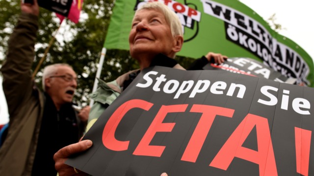 Consumer rights activists hold banners as they protest against CETA during Social Democrats meeting in Wolfsburg
