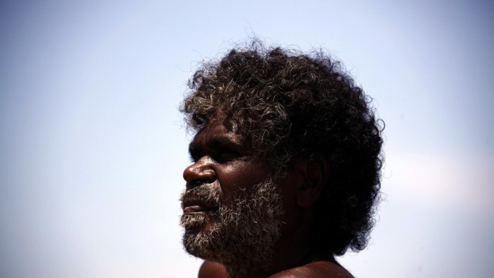 Australian Aboriginal hunter Bruce Gaykamangu looks across a billabong at potential prey near the 'out station' of Ngangalala, located on the outksirts of the community of Ramingining in East Arnhem Land