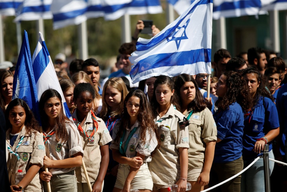 Israeli youth scouts hold Israeli flags as they pay their last respects to former Israeli President Shimon Peres, as he lies in state at the Knesset plaza, the Israeli parliament, in Jerusalem