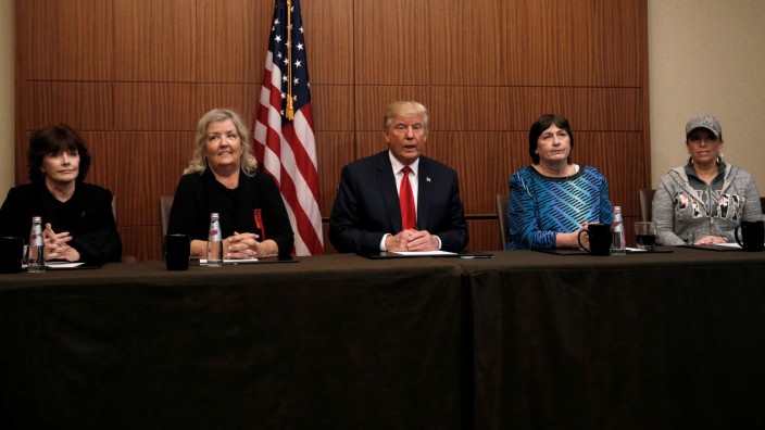 Republican presidential nominee Donald Trump sits with Paula Jones, Kathy Shelton, Juanita Broaddrick and Kathleen Wiley in a hotel conference room in St Louis, Missouri
