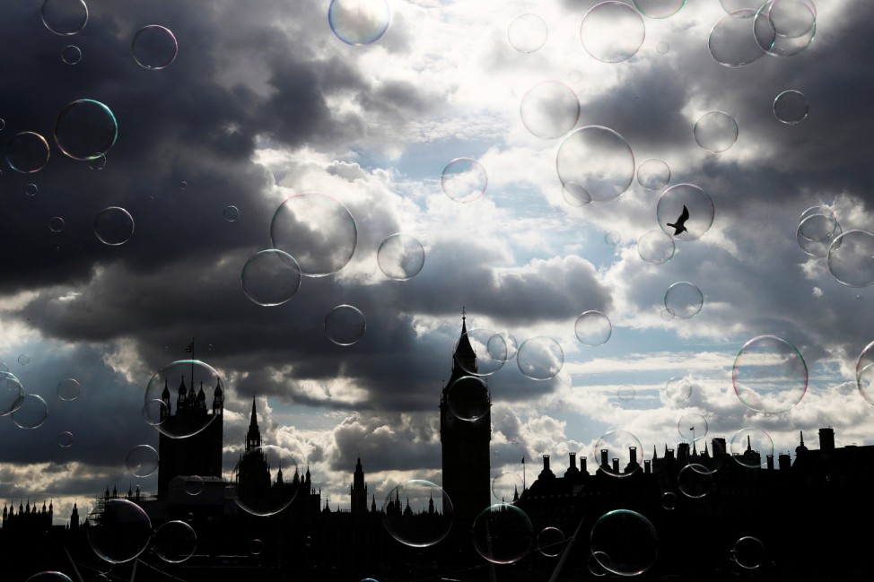 Soap bubbles float past the Houses of Parliament in central London
