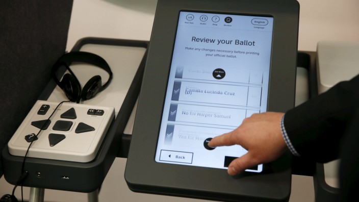 Los Angeles County Registrar-Recorder/County Clerk Dean Logan demonstrates a prototype of a new touchscreen voting machine in Norwalk