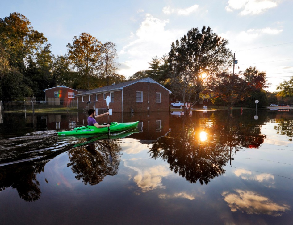 A resident paddles his kayak out of his neighborhood after checking the condition of his house as river levels rise into town in the aftermath of Hurricane Matthew, in Greenville, North Carolina