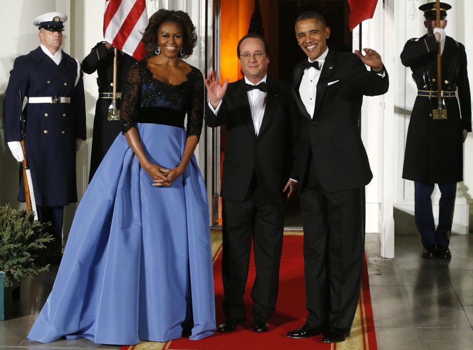 Obama and his wife Michelle greet Hollande as he arrives for a State Dinner in his honor at the White House in Washington