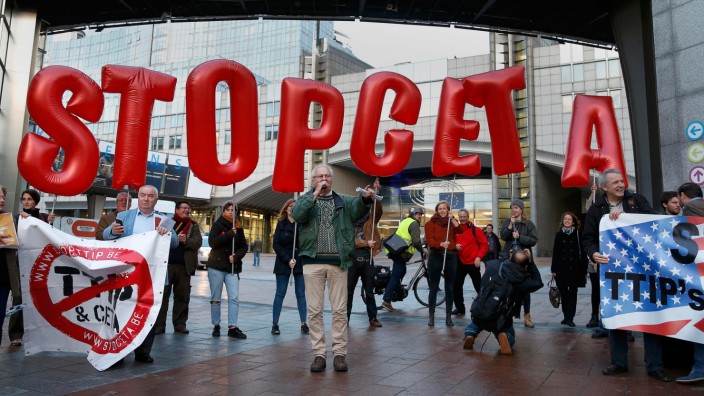Demonstrators protest against CETA outside the EU summit in Brussels