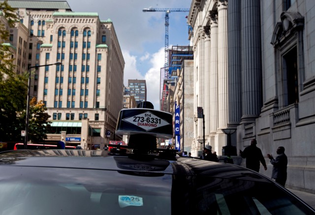 Taxis block the streets in the downtown core for their protest against Uber in Montreal