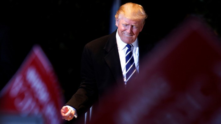 Republican presidential nominee Donald Trump pumps his fist after a campaign event in Cedar Rapids