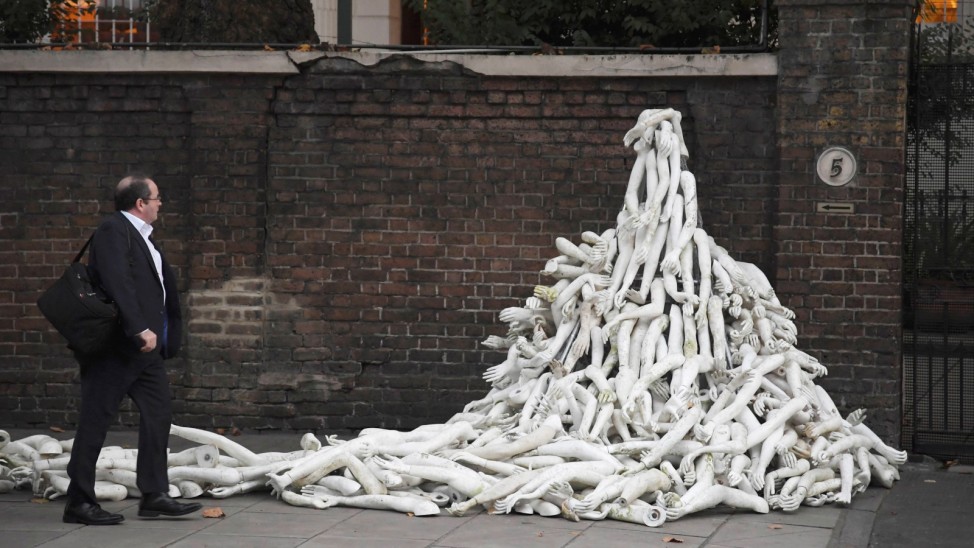 Piles on mannequin limbs are seen outside the Russia's embassy in London as part of a protest against military action in Syria