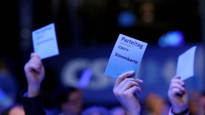 Delegates of CSU raise voting cards at CSU party congress in Munich