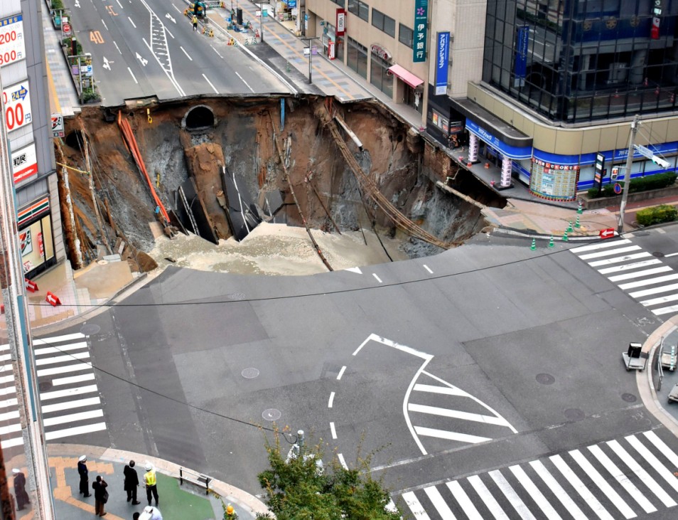 A huge sinkhole is seen at an intersection near Hakata station in Fukuoka