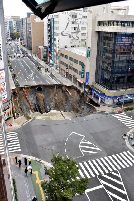 Sinkhole disrupts traffic in central Fukuoka A huge sinkhole is pictured at a crossing near JR Hakat