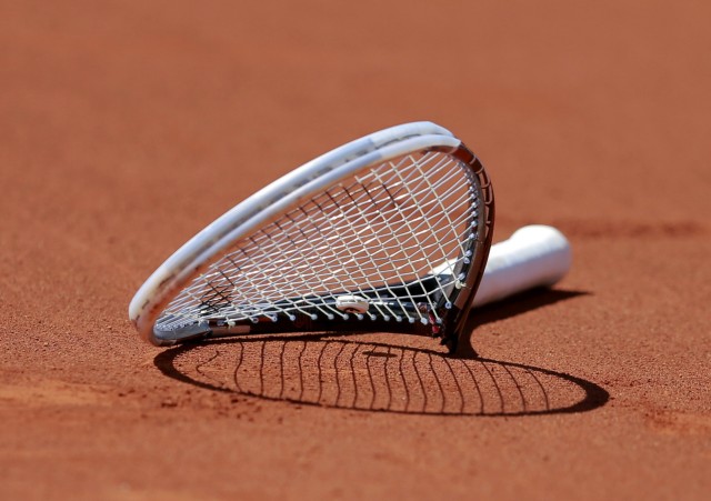 The broken racket of Novak Djokovic of Serbia is seen on the court after he smashed it during his men's semi-final match against Ernests Gulbis of Latvia at the French Open tennis tournament at the Roland Garros stadium in Paris