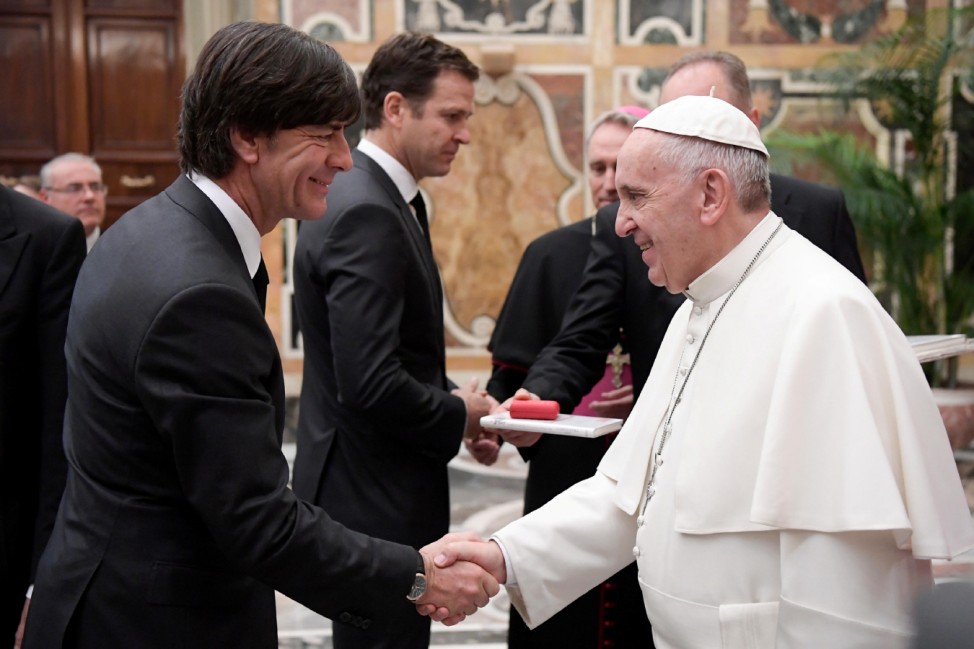 Pope Francis greets Germany's coach Joachim Low during a private audience with German national soccer team at the Vatican