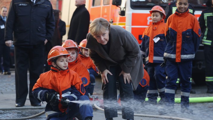 Merkel Visits Youth Fire Department Ahead Of Integration Summit