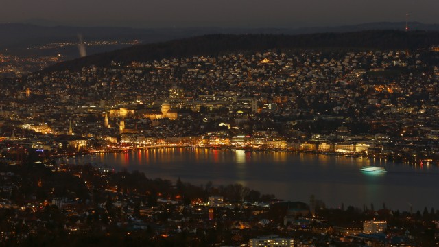 A night view shows the city of Zurich and Lake Zurich