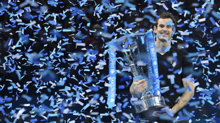 Great Britain's Andy Murray celebrates winning the final against Serbia's Novak Djokovic with the ATP World Tour Finals trophy