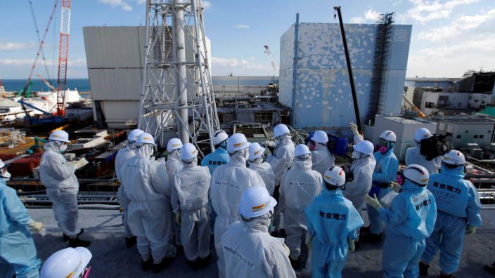 Members of the media receive briefing from Tokyo Electric Power Co. employees at tsunami-crippled Fukushima Daiichi nuclear power plant in Okuma town, Fukushima prefecture