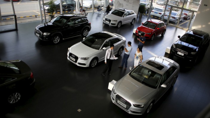 File photo of customers looking at cars at an Audi dealership from the Baoxin Auto Group in Shanghai