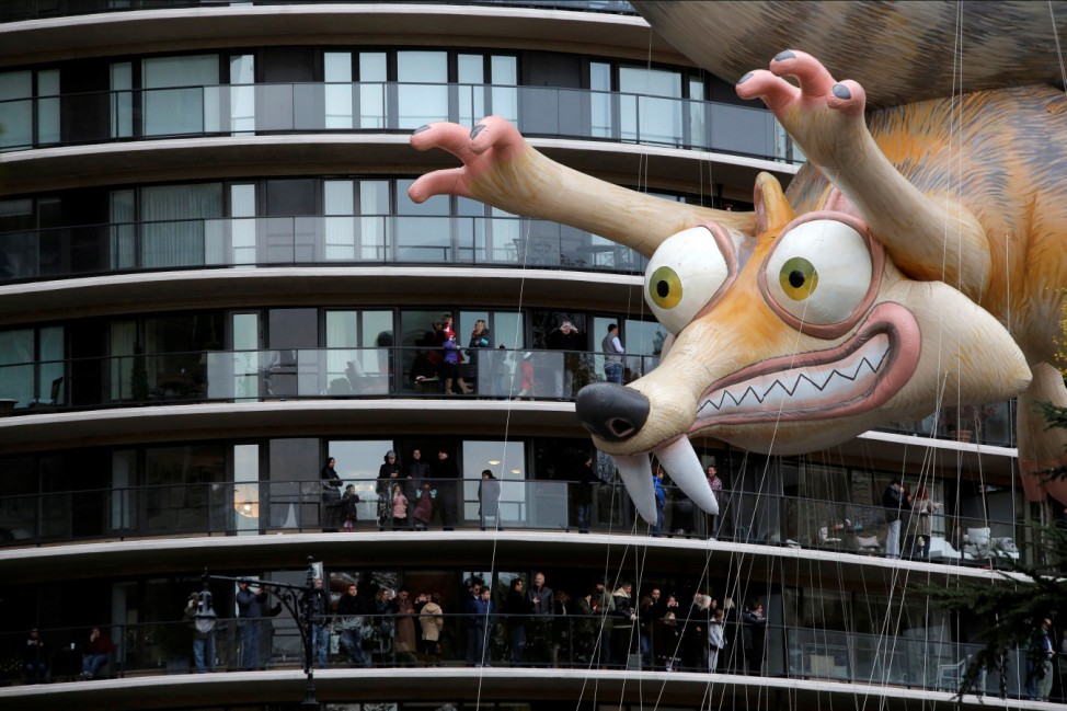 Ice Age's Scrat balloon is carried by crowds gathered on terraces along West 59th Street during the 90th Macy's Thanksgiving Day Parade in Manhattan, New York, U.S.