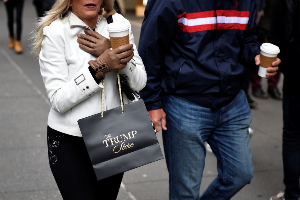 A woman carries a bag from The Trump Store after shopping at Trump Tower along Fifth Avenue in the Manhattan borough of New York