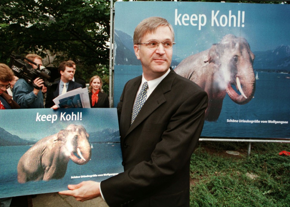 CDU PARTY MANAGER HINTZE DISPLAYS ELECTION CAMPAIGN POSTER IN BONN